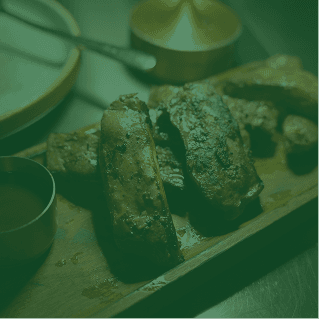 Grilled steak resting on a wooden board