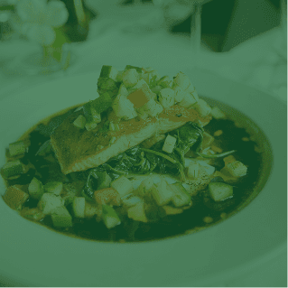 Pan-seared fish over sautéed greens